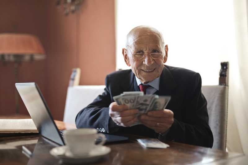 A person sitting at a table reading a book Description automatically generated with medium confidence